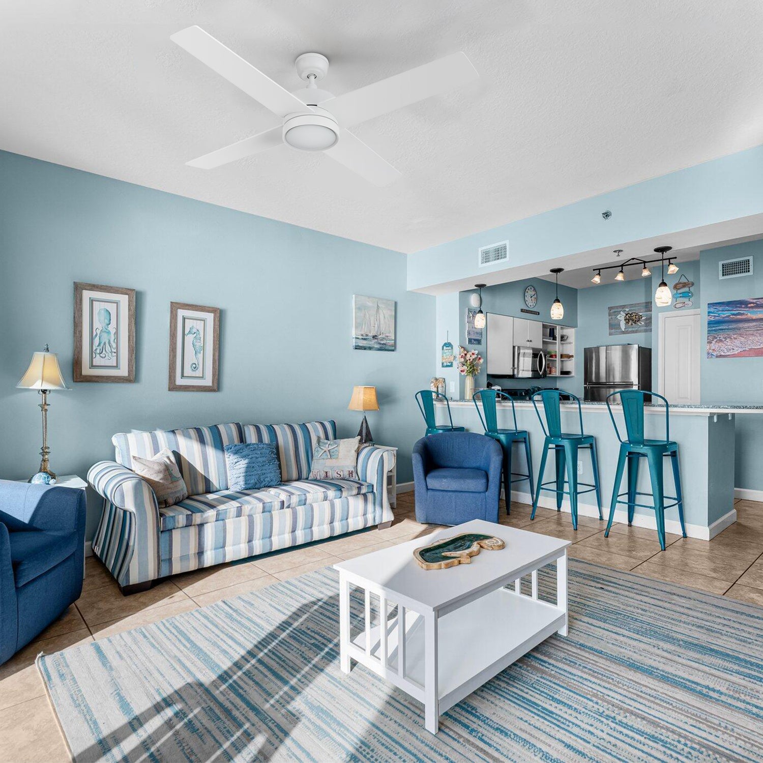 Smafan Rossendale 52-inch white ceiling fan with LED light installed in a coastal-style living room with blue accents and a white coffee table. 