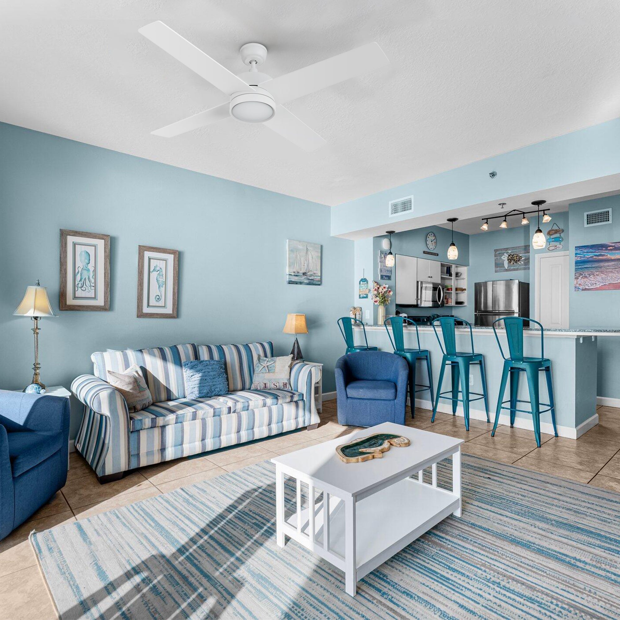 Smafan Rossendale 52-inch white ceiling fan with LED light installed in a coastal-style living room with blue accents and a white coffee table. 