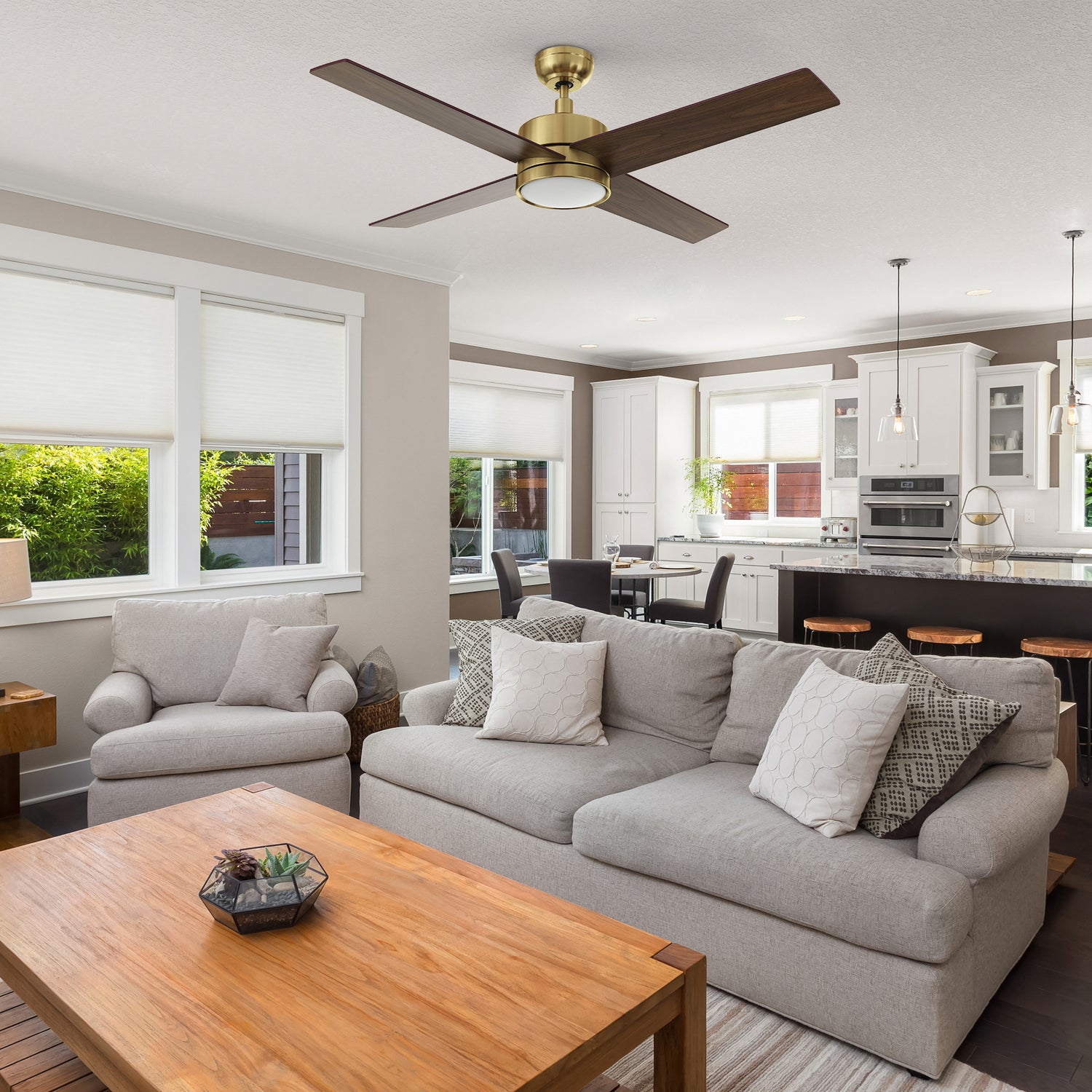 Modern living room featuring the Carro Smafan Rossendale 52-inch ceiling fan with LED light in a brushed gold finish. 