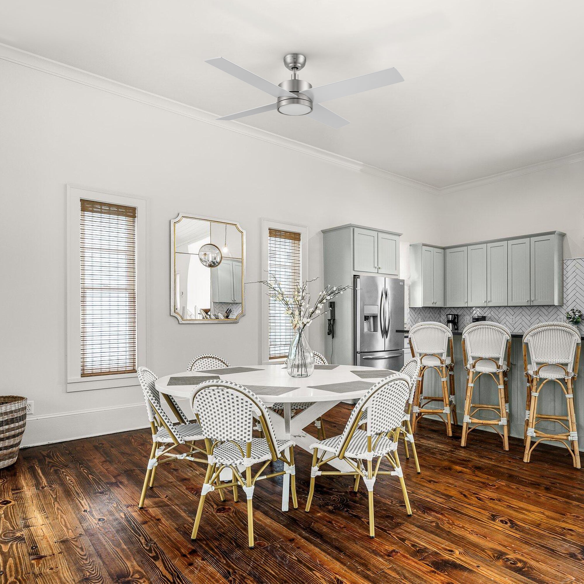 Smafan Rossendale 52-inch brushed nickel ceiling fan in silver with LED light in a rustic-style kitchen with wooden floors and white dining furniture. 