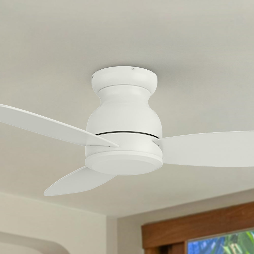 Side angle view of the white Osborn flush mount ceiling fan installed on a ceiling, highlighting its modern and compact build. #color_white