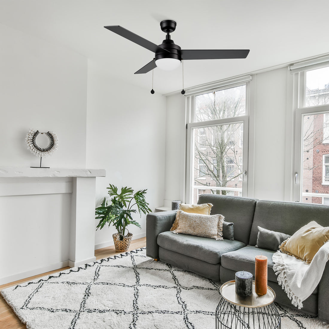 52 inch modern ceiling fan in black with light well matches the grey sofa in modern living room 