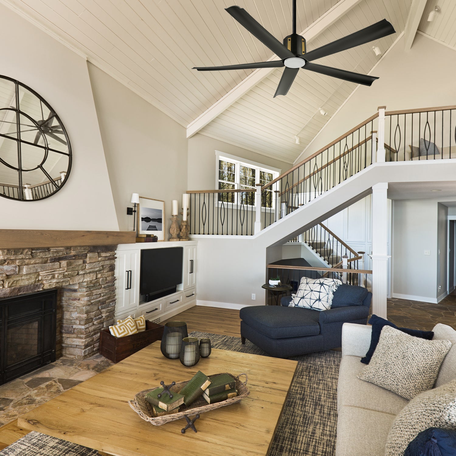 The Zahar 60-inch black ceiling fan with LED light is installed in a farmhouse-style living room, enhancing the space with its sleek design. 
