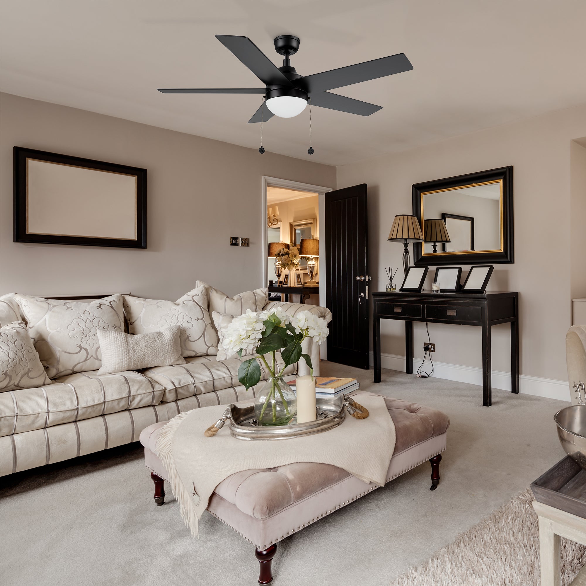 Black ceiling fan with LED light 52 inch matches to beige furniture, luxurious black gold frame wall mirror, the whole living room is noble and elegant. 