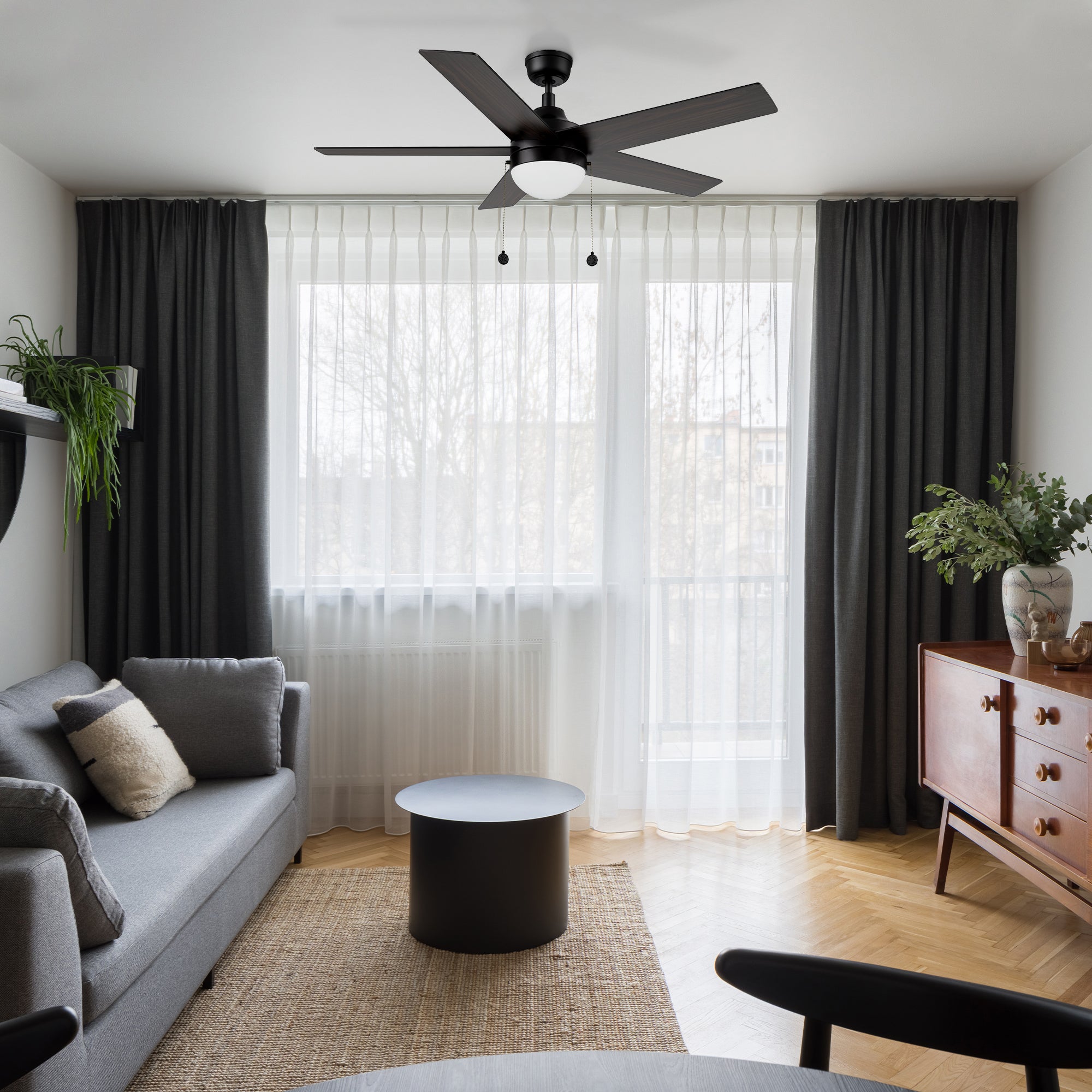 5 speed Quiet DC motor ceiling fan in black matches well with the long floor curtains in the modern living room. 