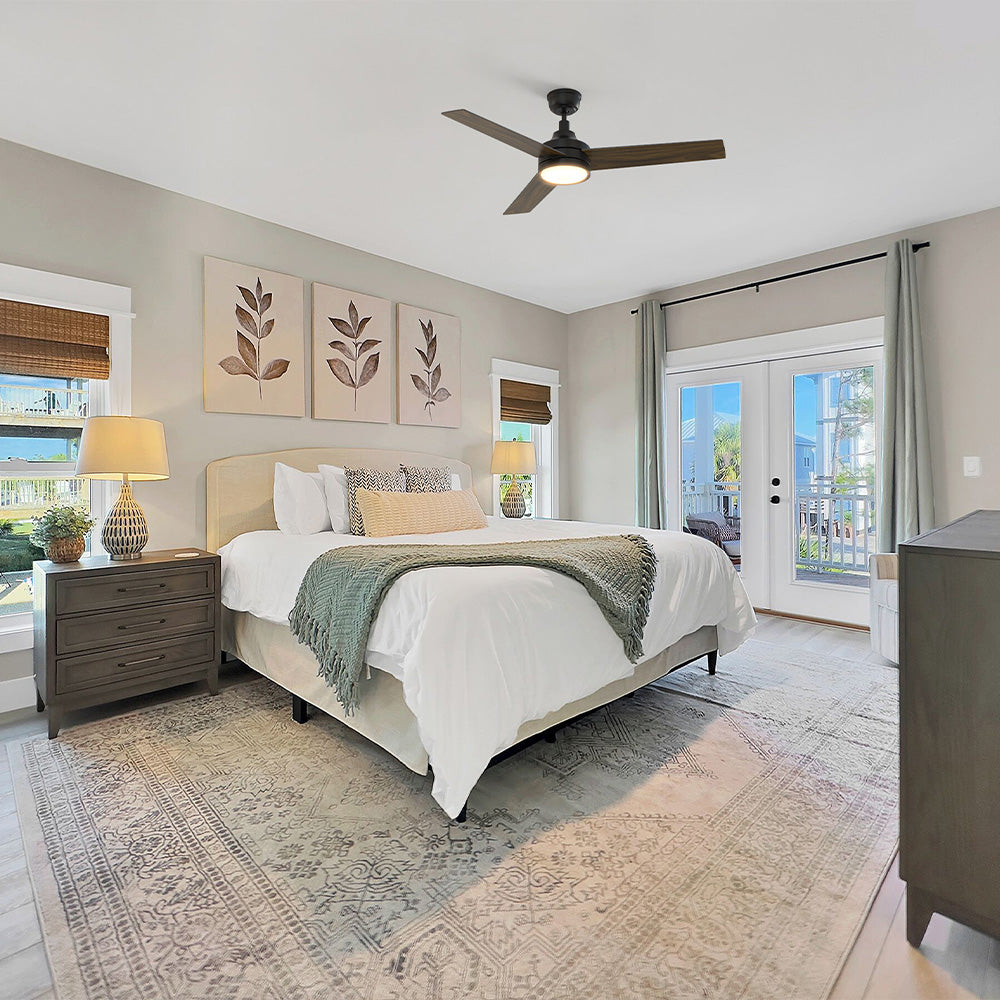 Smafan Dulon 52 inch modern matte black 3 blade ceiling fan with light installed in a serene modern coastal bedroom with neutral decor and French doors. 