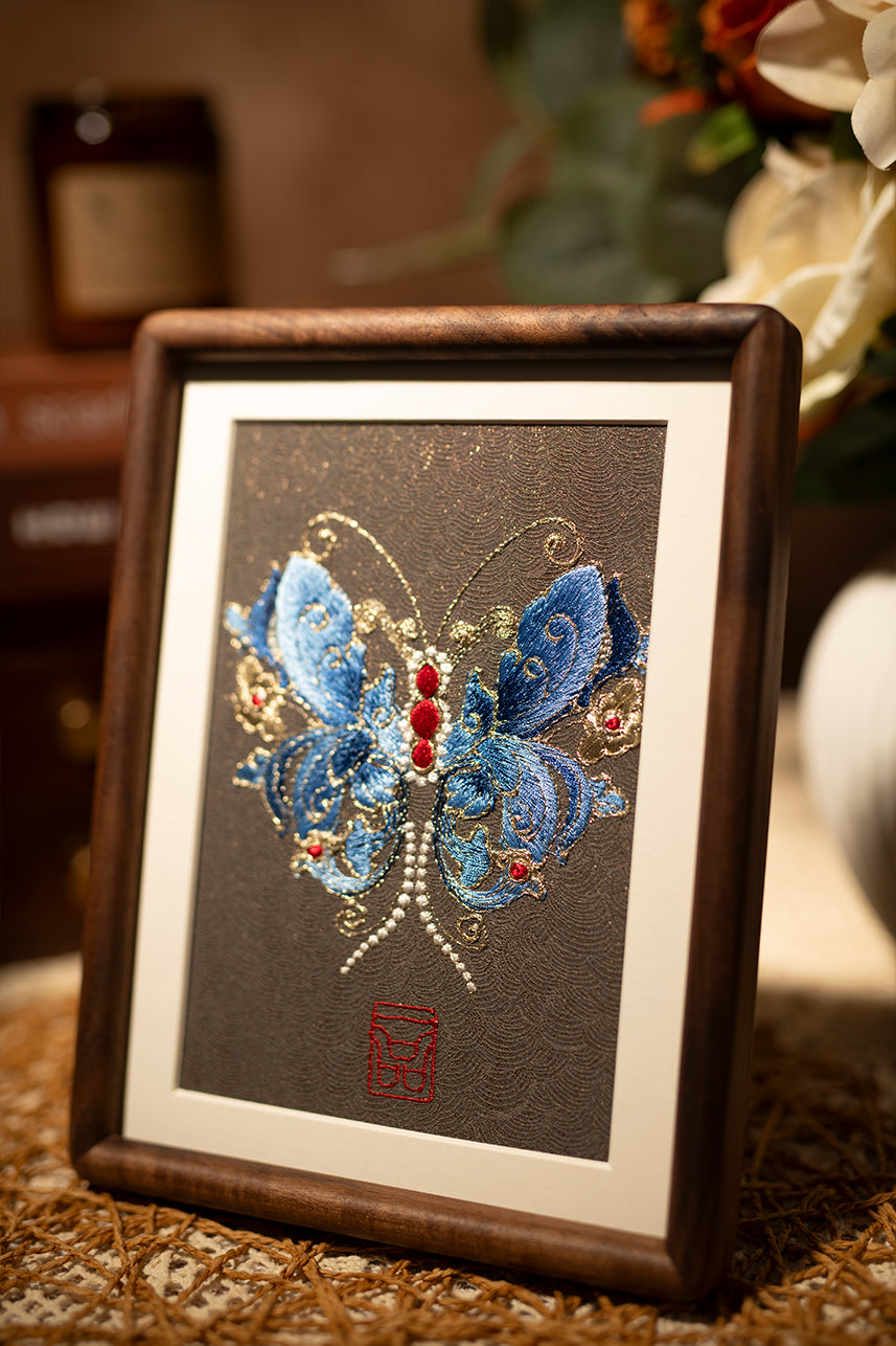This embroidery design shows us with blue and shining butterfly, is a beautiful textile wall art.