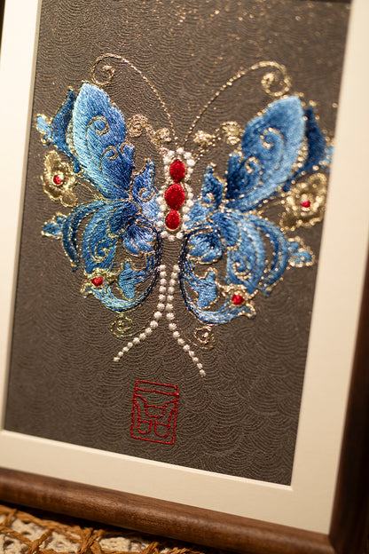 This embroidery design shows us with blue and shining butterfly, is a beautiful textile wall art which dade of various color silk threads.