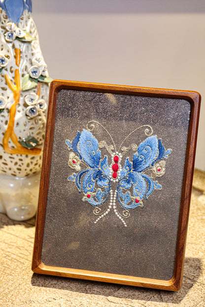 This embroidery design shows us with blue and shining butterfly, is a beautiful desk decoration which made of various color silk threads.