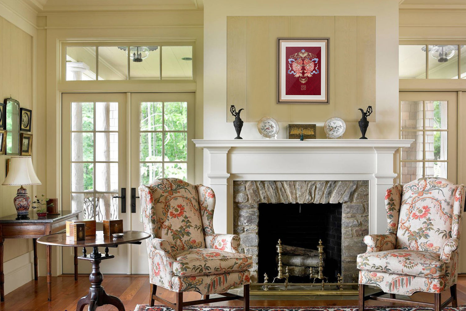 An embroidered artwork with double koi fish hangs above the vintage-inspired living room fireplace.