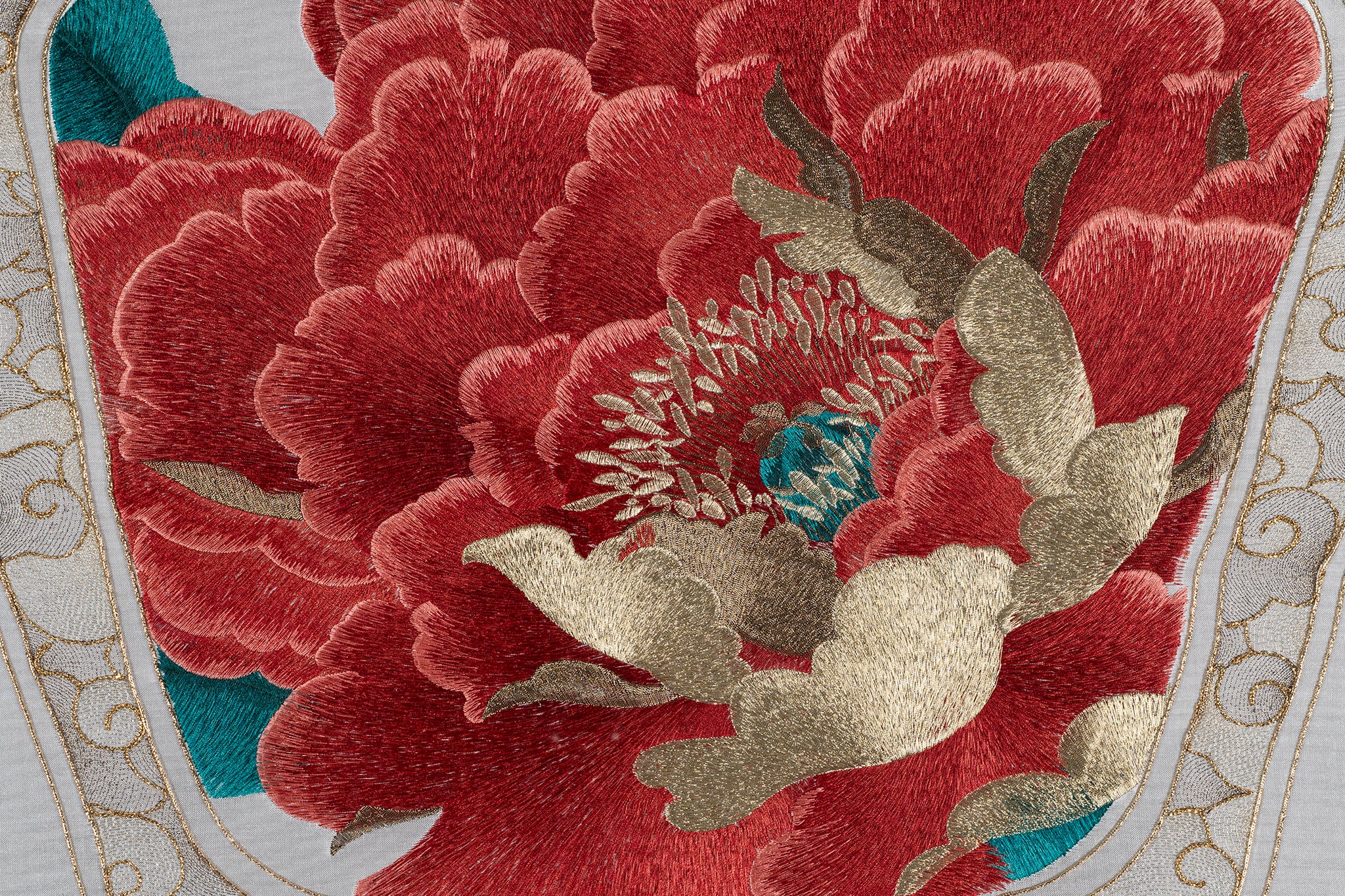 The outer petals of the peony are all embroidered with bright red silk thread