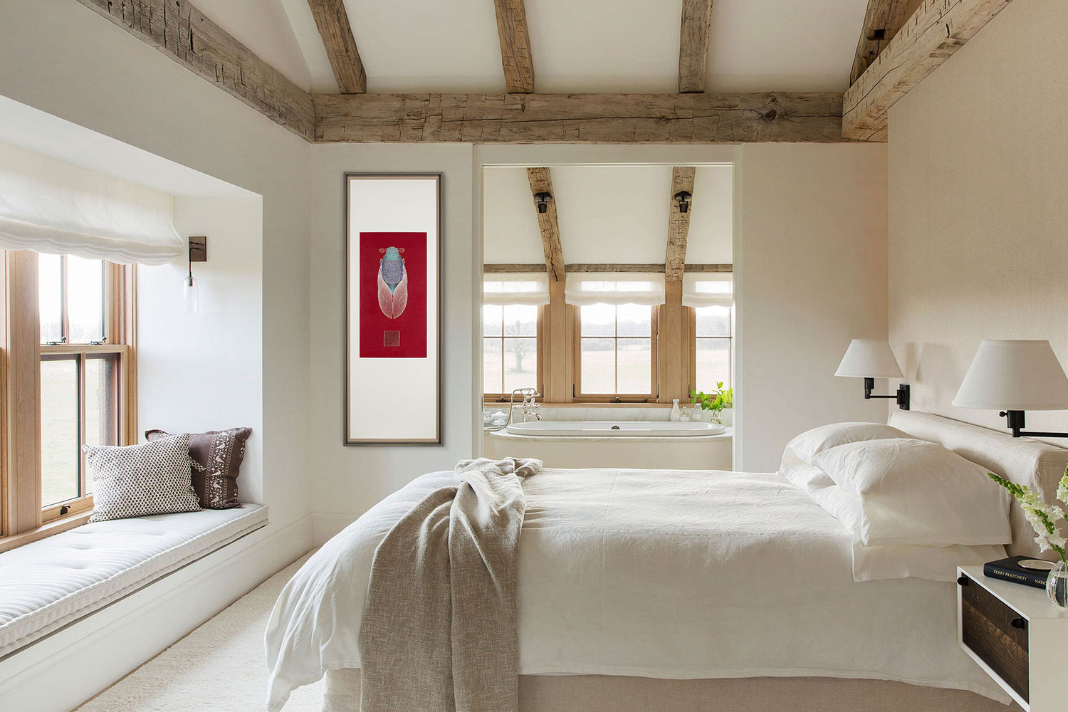 A bedroom with white bedding and wooden ceiling beams. A framed embroidery artwork featuring a cicada design hangs on the wall.