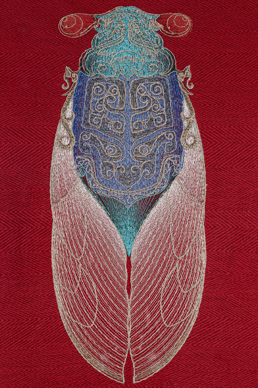 Close-up of the entire cicada design in a framed embroidery artwork. The intricate embroidery showcases detailed patterns in blue, white, and red threads on a red background.
