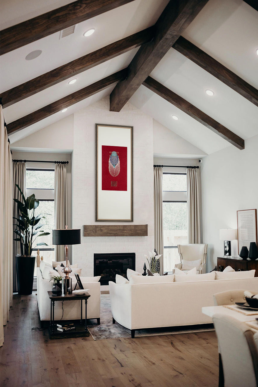 A spacious living room with wooden beams on the ceiling and a mix of modern and traditional furniture. A framed embroidery artwork featuring a cicada design is displayed prominently on the wall.