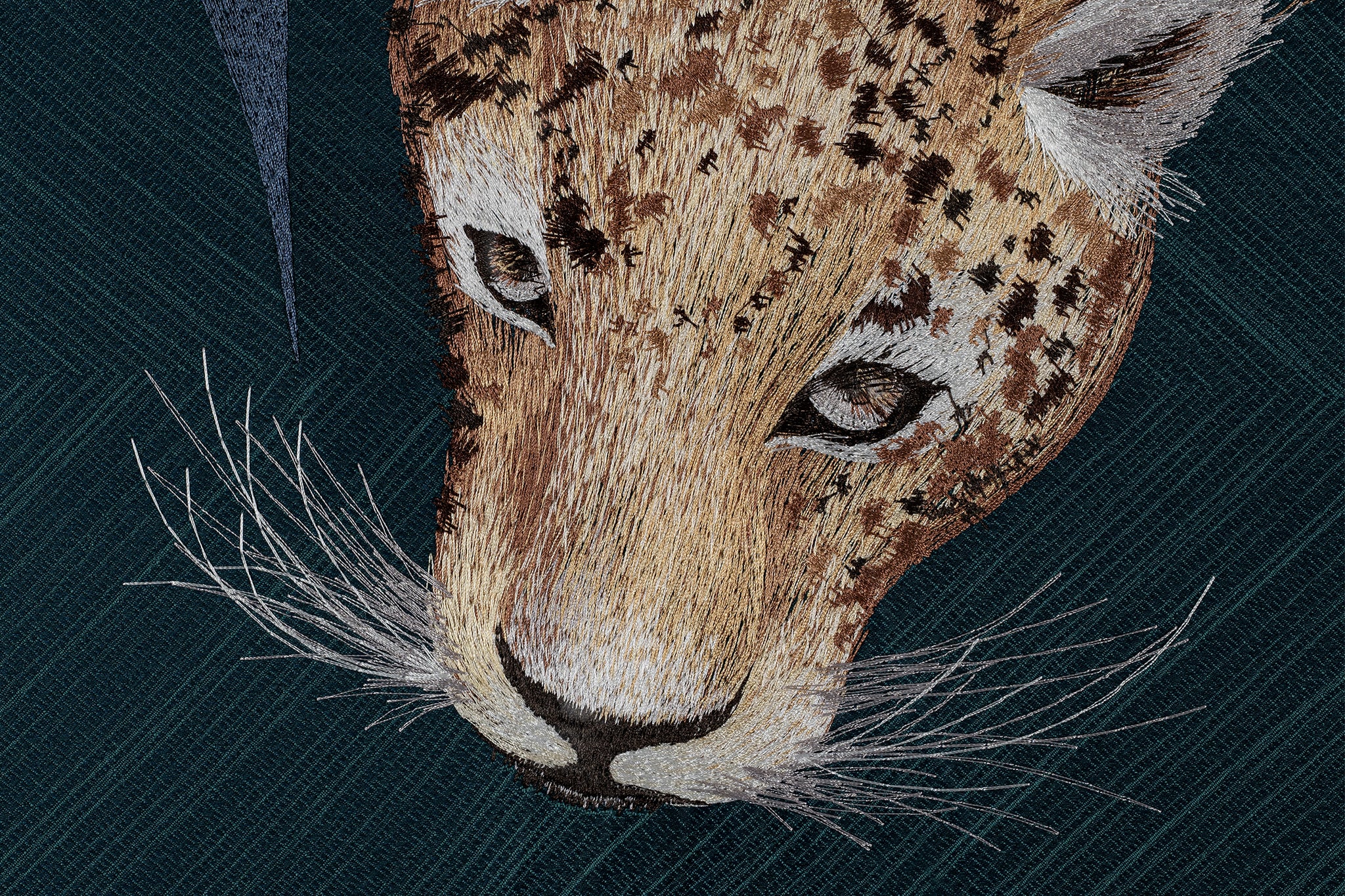 The eyes details of the leopard design in embroidery fine wall art.