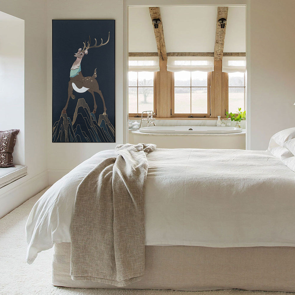 Framed embroidery fine wall art of a sika deer design displayed in a cozy bedroom setting.