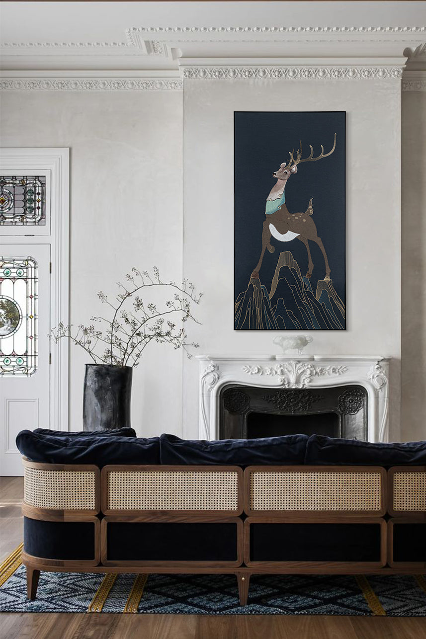 Framed embroidery fine wall art of a sika deer design displayed in a modern living room with stylish decor.