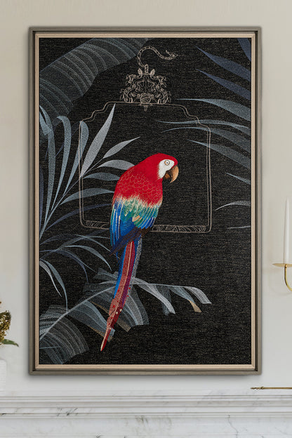 An embroidered macaw sits on a perch next to an embroidered artwork on a black background decorated with palm leaves.