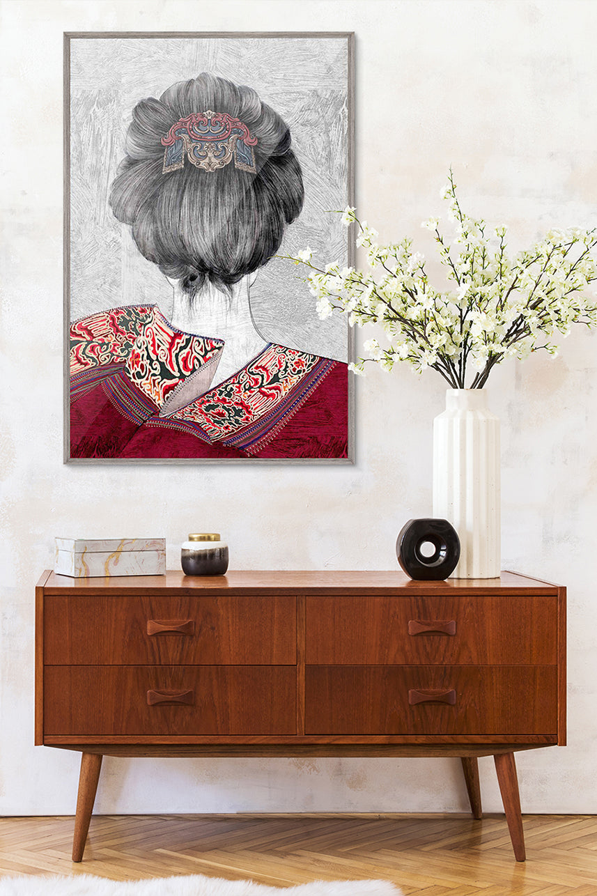 An framed embroidery art work embroidered with the back of a female figure is hung on the wall above the side table, with elegant milky white artificial cherry blossoms, which makes the whole living room very artistic.