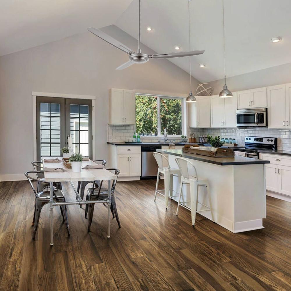 Kade 56-inch brushed nickel ceiling fan with remote control, installed in a stylish dining room. Silver finish complements modern interiors and enhances airflow. 