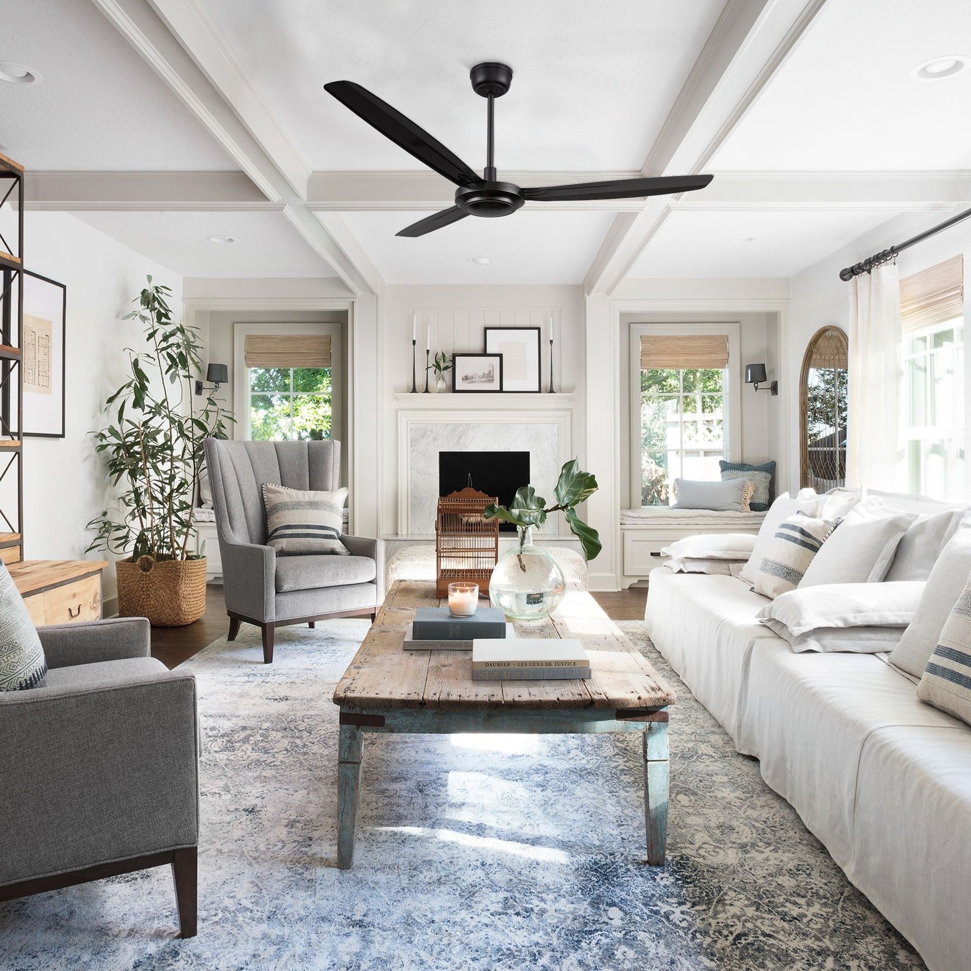 Modern living room with large windows, featuring the Kade 56-inch black ceiling fan with remote control, providing powerful airflow and contemporary style. 