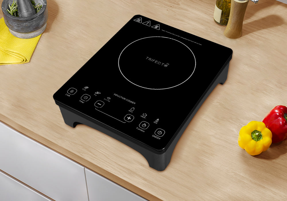 11" black portable induction cooktop with black crystal plate is placed on the kitchen counter and near bell peppers