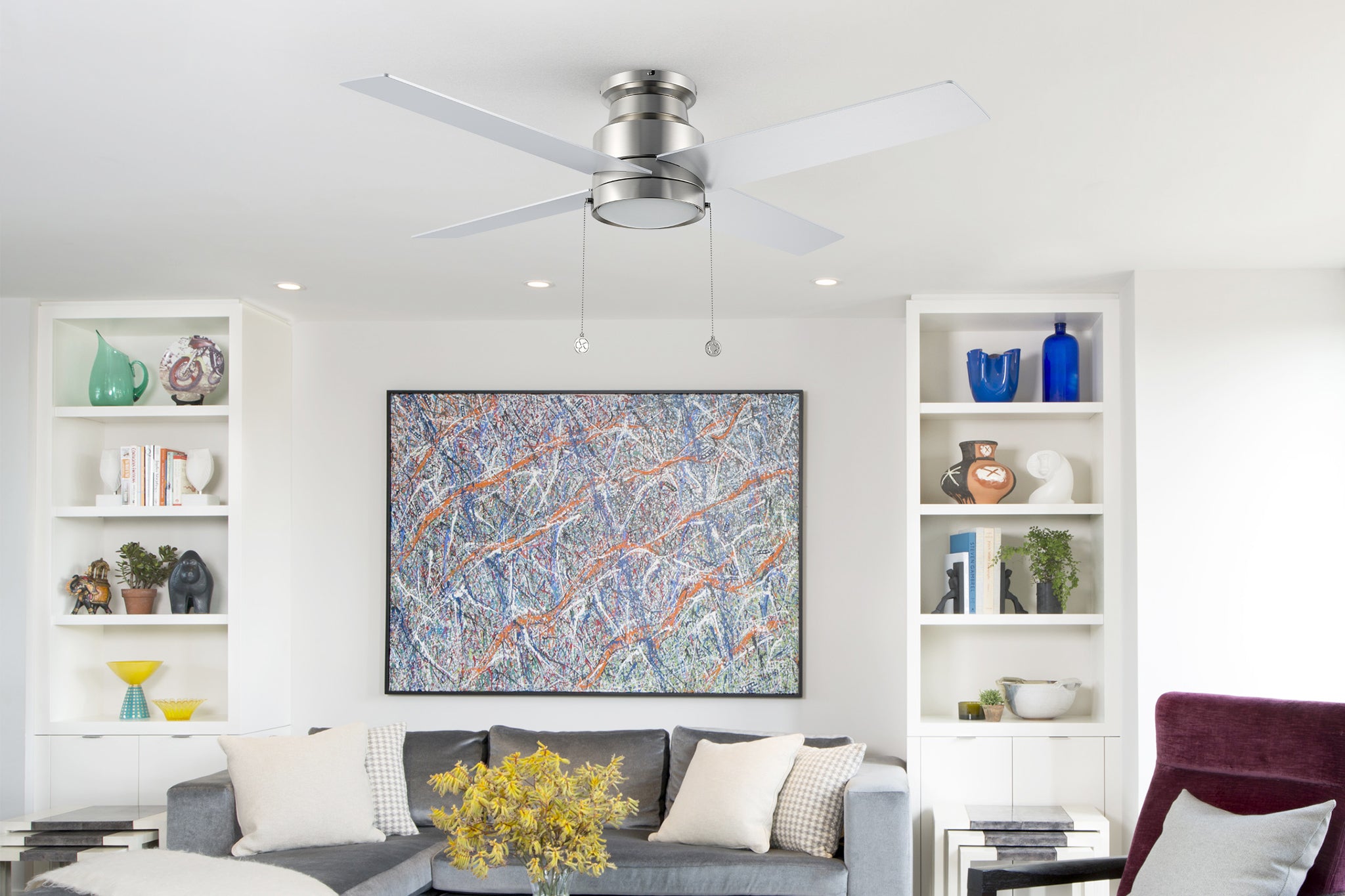 Luft low profile ceiling fan with light and silver color design in modern living room.