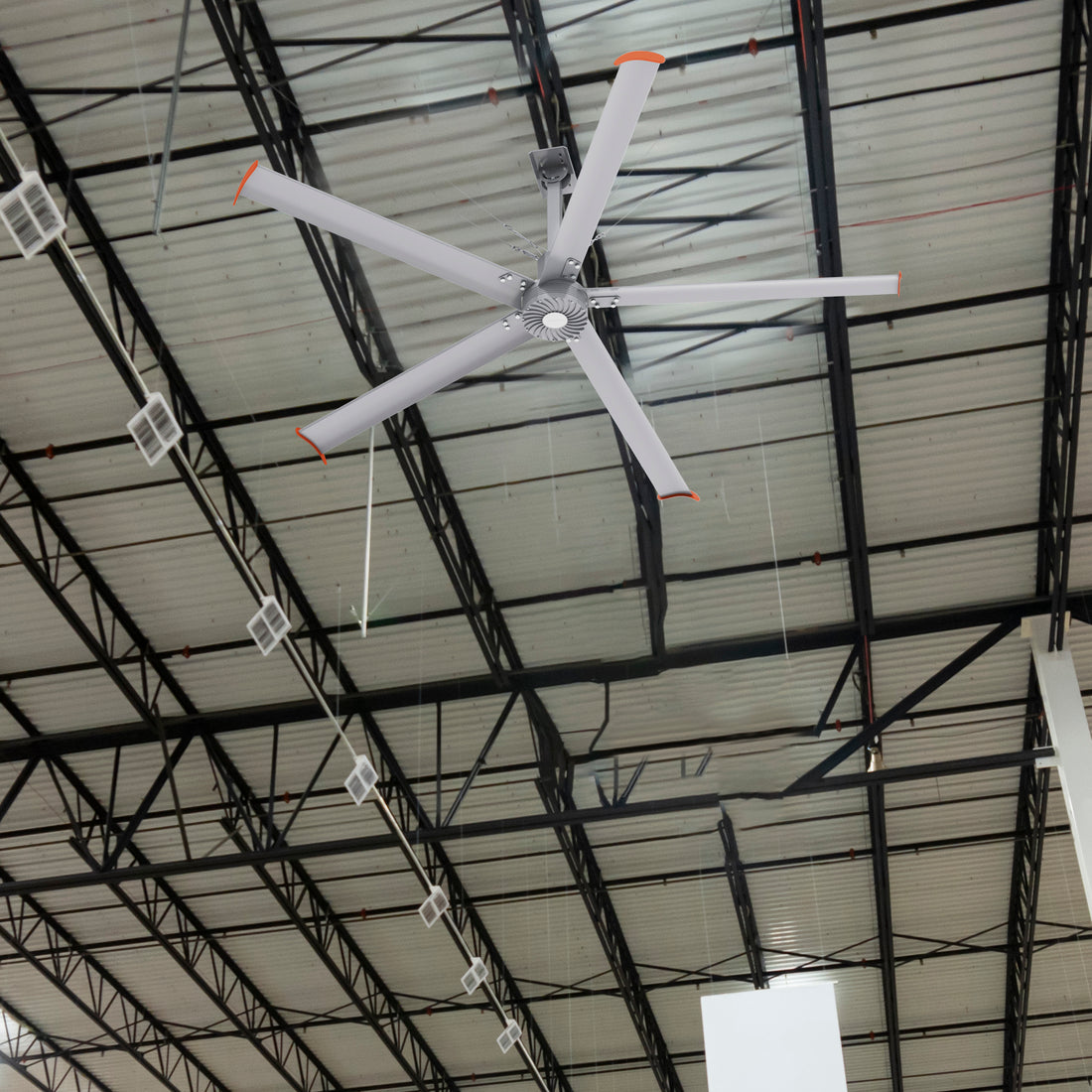 Makani 10ft industrial HVLS fan installed in a factory, efficiently circulating air in a large open industrial space with high ceilings. 