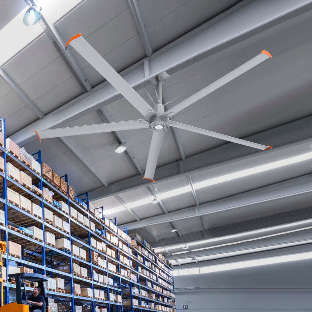 Makani 12ft industrial HVLS ceiling fan in a distribution center, powered by 240V, enhancing airflow efficiency in a busy logistics hub filled with high racks and packed boxes. 