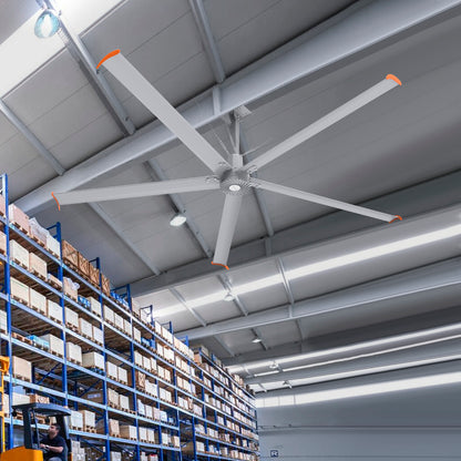 Makani 12ft industrial HVLS ceiling fan in a distribution center, powered by 480V, enhancing airflow efficiency in a busy logistics hub filled with high racks and packed boxes. 