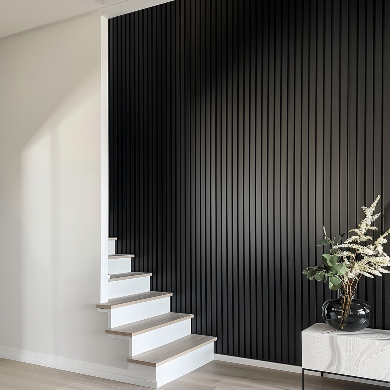 Black matte acoustic slat wall panels installed along a stairway, adding sleek, modern texture to the minimalist interior design.