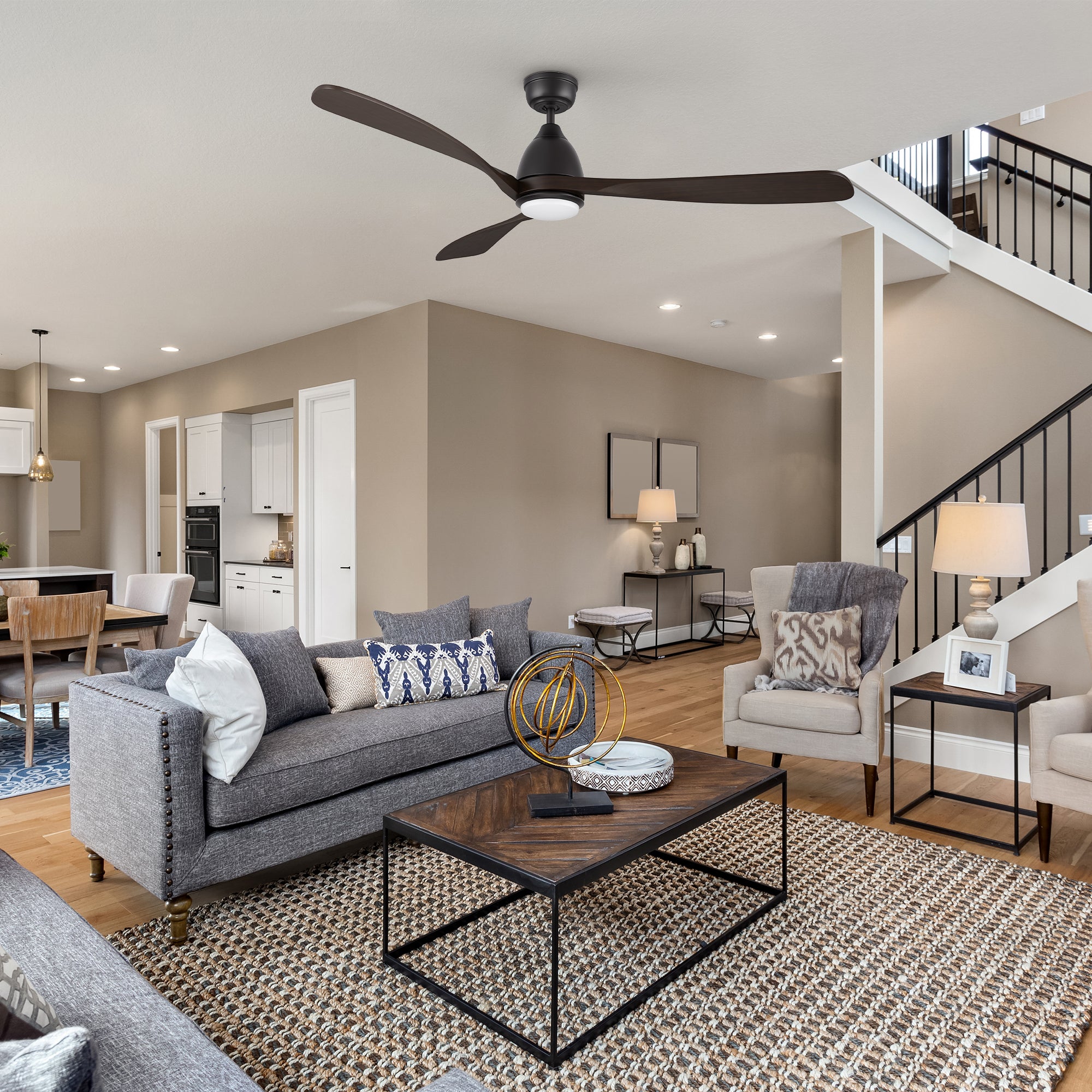 The Nephele LED lighting ceiling fan with a sleek black design is mounted in a spacious, modern living room with a white and neutral color palette, delivering powerful yet quiet airflow. 