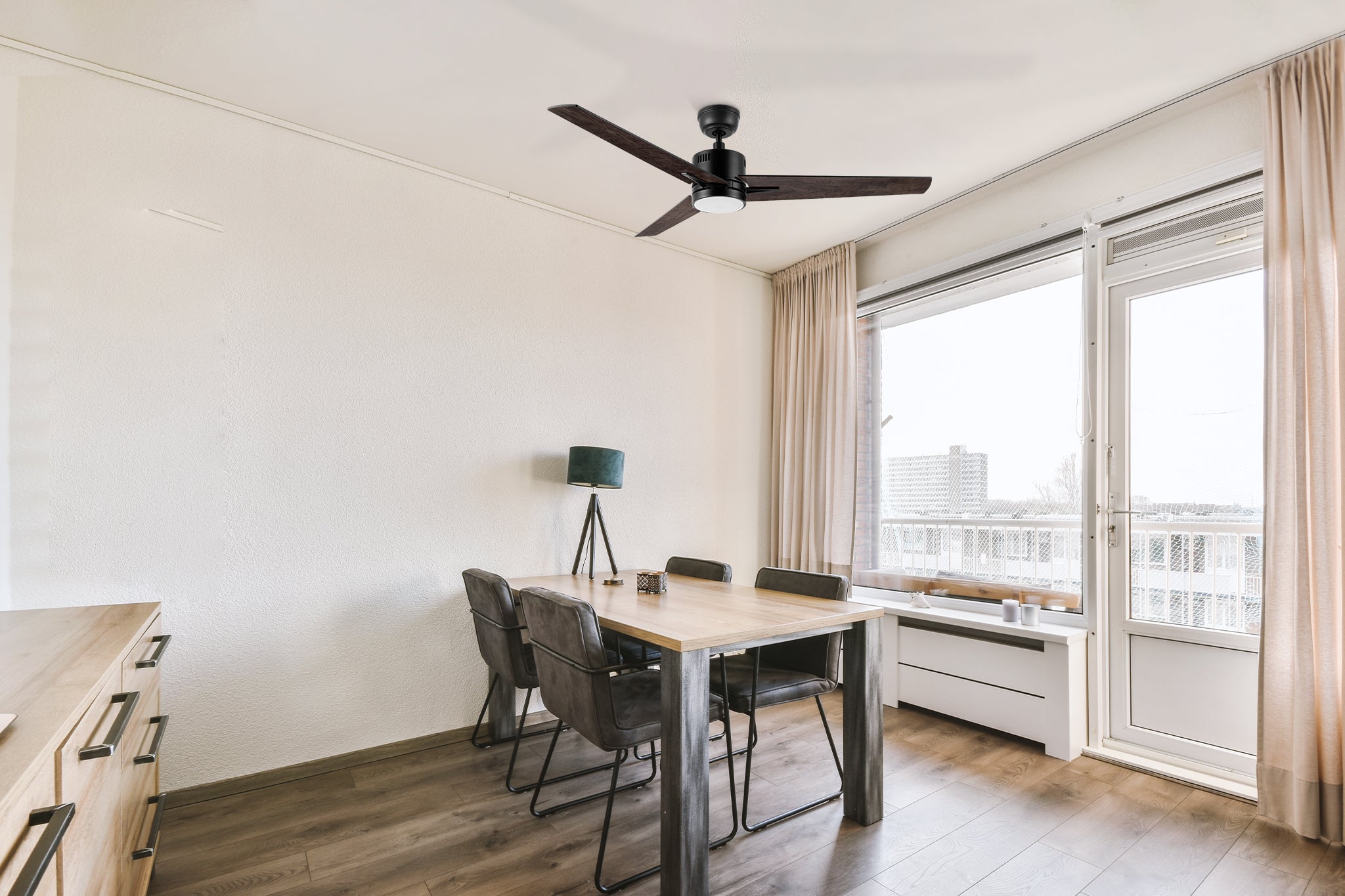 Skobeleoff 52-inch ceiling fan with LED light, stylishly installed in a dining room, offering quiet and efficient airflow.