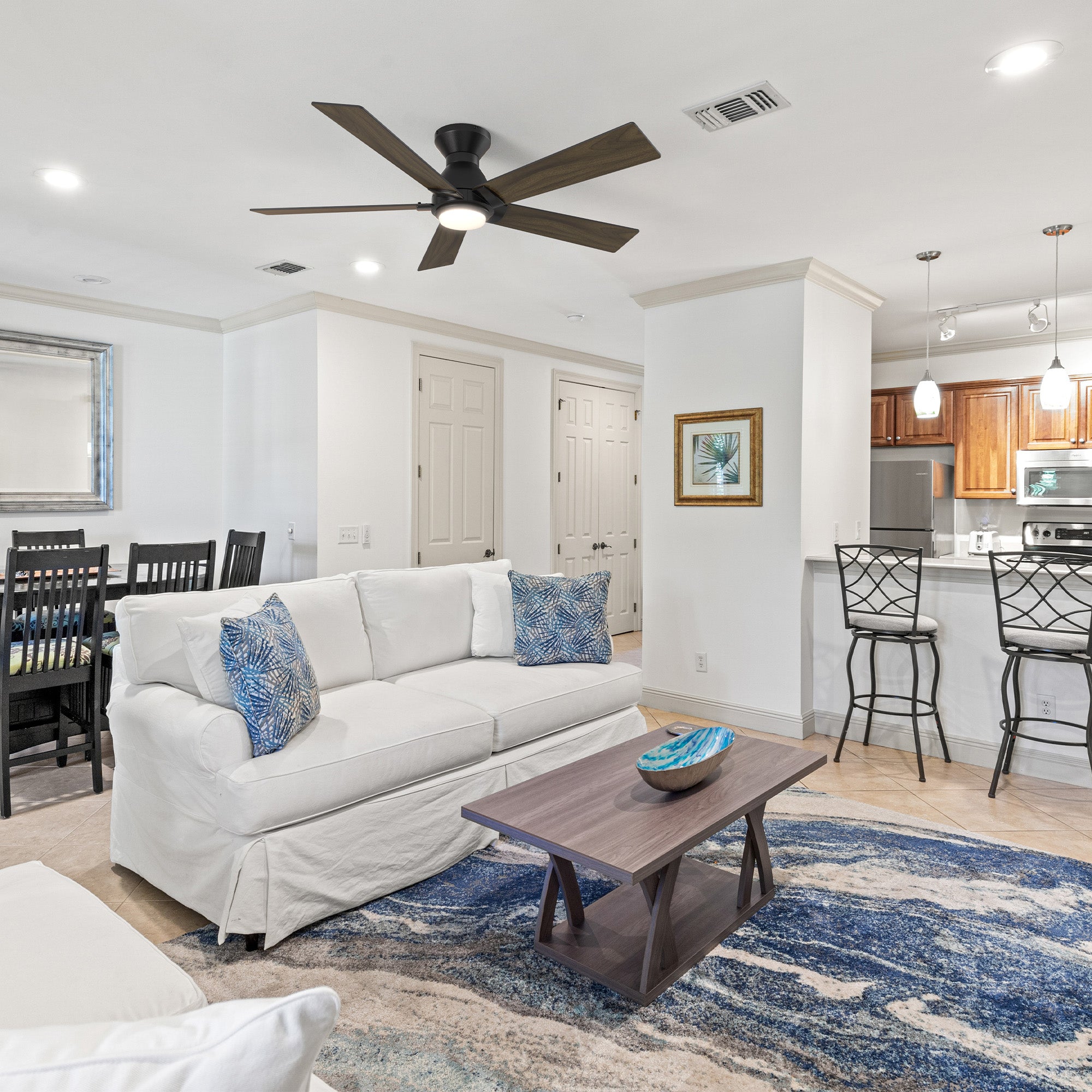 Carro Armoy 52 inch low profile remote control ceiling fan with light, 5 blades, dark wood design, installed in living room. 