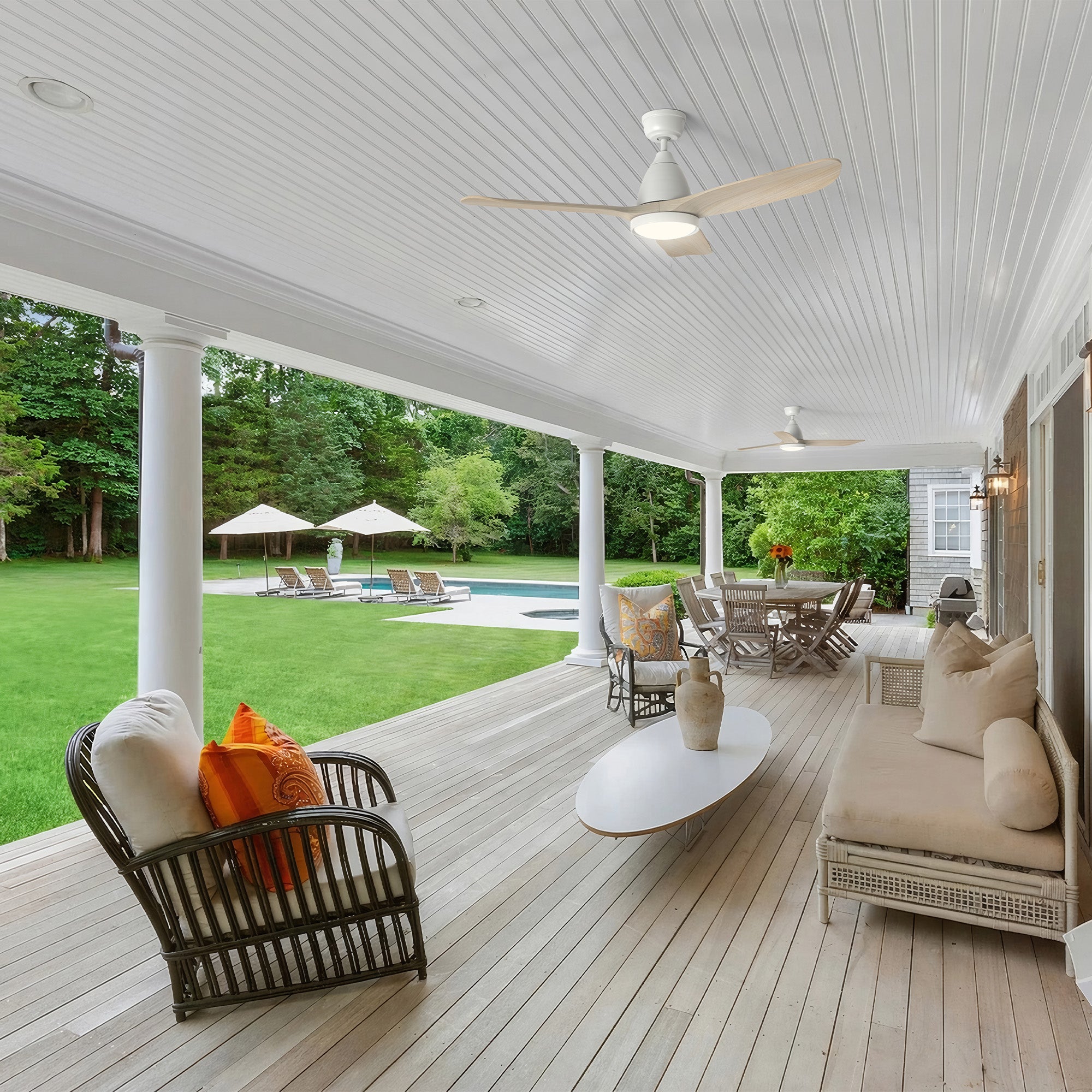 The Koa 52" outdoor smart ceiling fan with light perfectly complements this covered patio with its natural wood-tone blades and sleek white body. It delivers powerful airflow and soft lighting, creating a cool, relaxing retreat for outdoor lounging and dining. 
