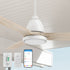  Close-up view of the Smafan Carro Koa II 52-inch outdoor ceiling fan with light, showcasing a sleek white motor housing and curved light wood finish blades. Includes wall control, handheld remote, and smartphone app interface for smart control. Installed in a covered outdoor setting. 