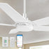 An image of a Carro 52-inch Smart Ceiling Fan with LED light, featuring white blades, mounted on a beige ceiling for efficient airflow and cooling. The ceiling fan is shown with a Carro white wall switch, a handheld remote, and a smartphone displaying a control app, highlighting smart operation for customizable lighting and cooling in indoor settings. 