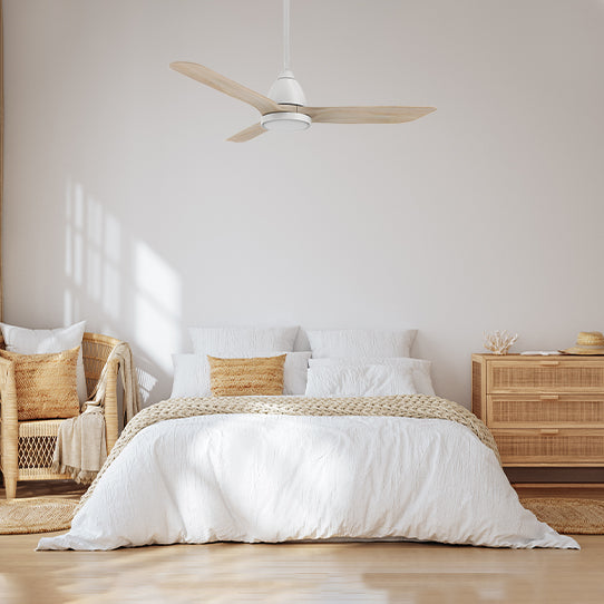 A 52-inch ceiling fan, mounted with a white downrod and featuring solid wood blades, is an ideal choice to enhance the elegance and artistic ambiance of a bedroom.