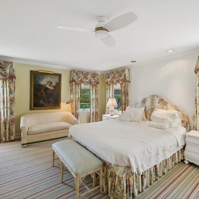 Smafan Biscay 52 inch white and gold flush mount ceiling fan with light installed in a luxury vintage bedroom.