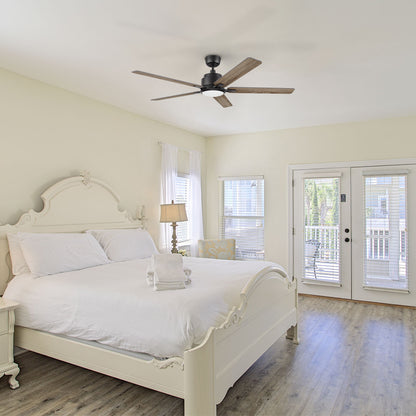 The Smafan Essex 56-inch Walnut ceiling fan installed in a bright, classic-style bedroom with white furniture, demonstrating its sleek low-profile design and suitability for indoor use in sleeping areas. 