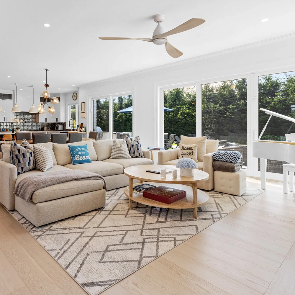 Nephele White 60 inch 3-blade light wood ceiling fan with LED light installed in a modern open concept living room with a white grand piano. 