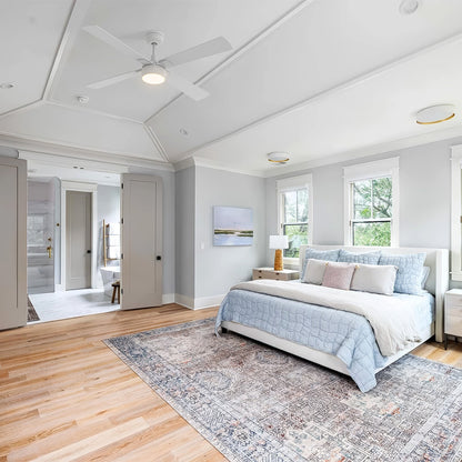 White Smafan Admiral 52-inch ceiling fan with light installed on a tray ceiling in a French Country bedroom with light blue bedding. 