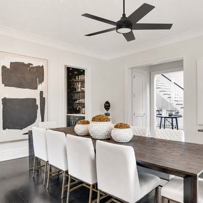 Smafan Albi 52 inch ceiling fan with light in matte black installed above a modern dining room. The five-blade ceiling fan complements a contemporary interior with a dark wood dining table, white upholstered chairs, abstract wall art, and clean architectural details, creating a sleek and sophisticated space. #color_black