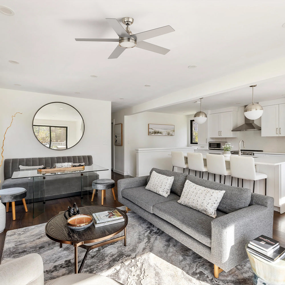 Smafan Albi modern contemporary ceiling fan with light featuring a 52 inch brushed nickel finish and 5 silver blades, installed in an open-concept living room with a grey sofa. 