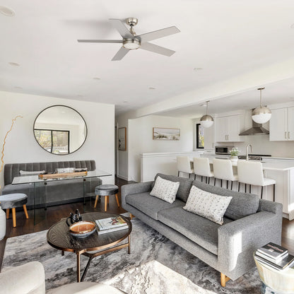 Smafan Albi modern contemporary ceiling fan with light featuring a 52 inch brushed nickel finish and 5 silver blades, installed in an open-concept living room with a grey sofa. 