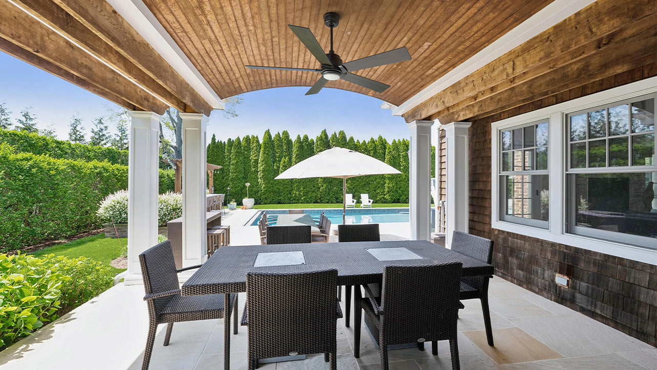 Covered outdoor patio featuring the Smafan Aspen 56 inch smart ceiling fan with light, mounted above a dining table overlooking a pool—ideal for Father's Day backyard gatherings.