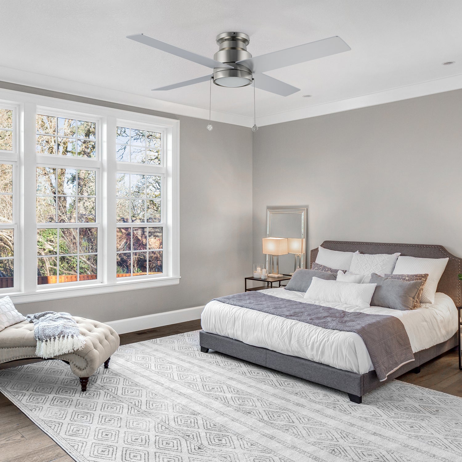 Carro Smafan Luft 52-inch modern ceiling fan with an LED light, featuring a sleek silver finish and 4 Polywood blades, elegantly displayed in a stylish bedroom setting.