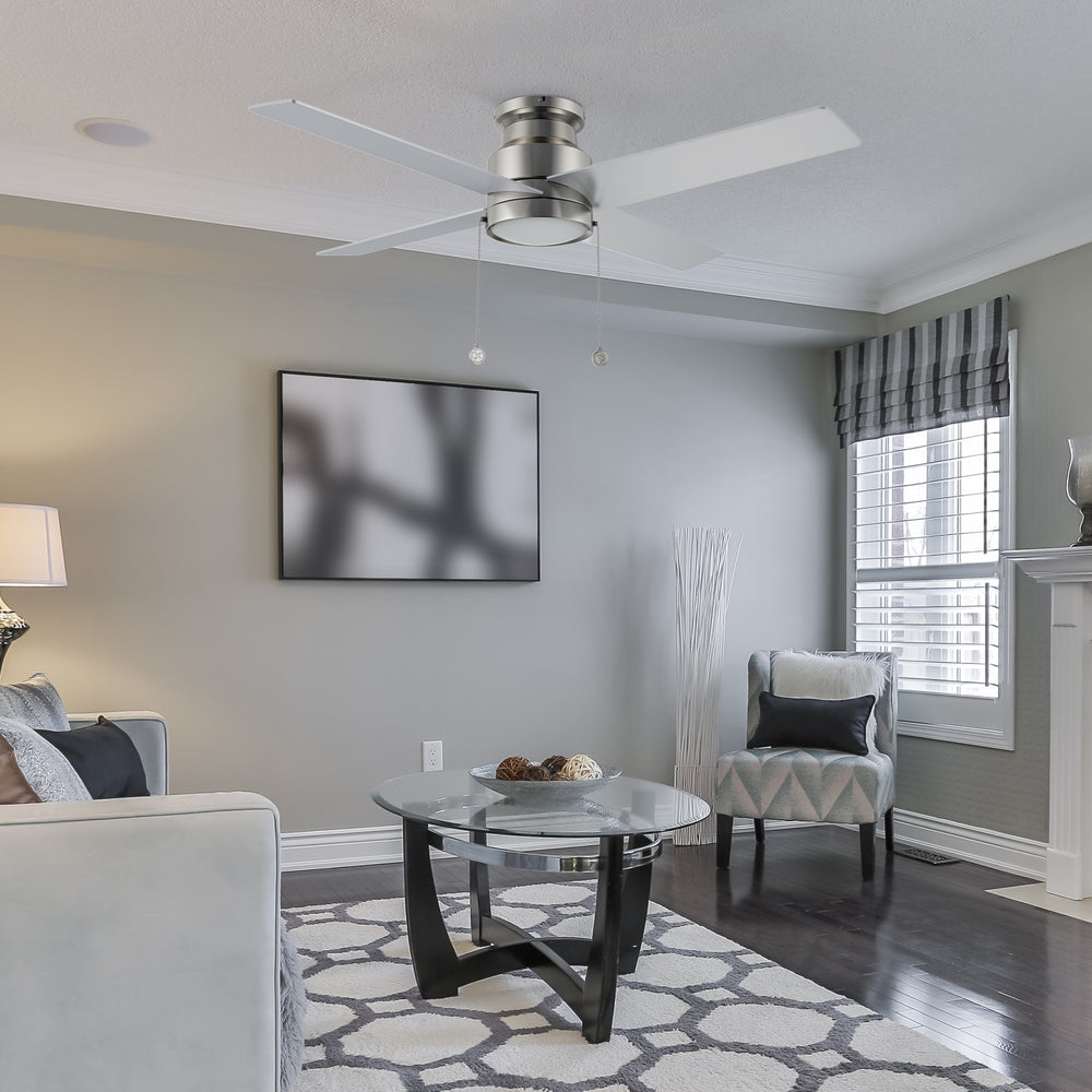 Carro Louy 52 inch modern ceiling fan with LED light in a silver finish, showcased in a spacious open living room area.