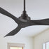 A 52-inch Smafan Kilk smart ceiling fan in black, without light, mounted on a white ceiling in a room with light beige walls, a window with blinds, and a simple indoor setting visible in the background. 