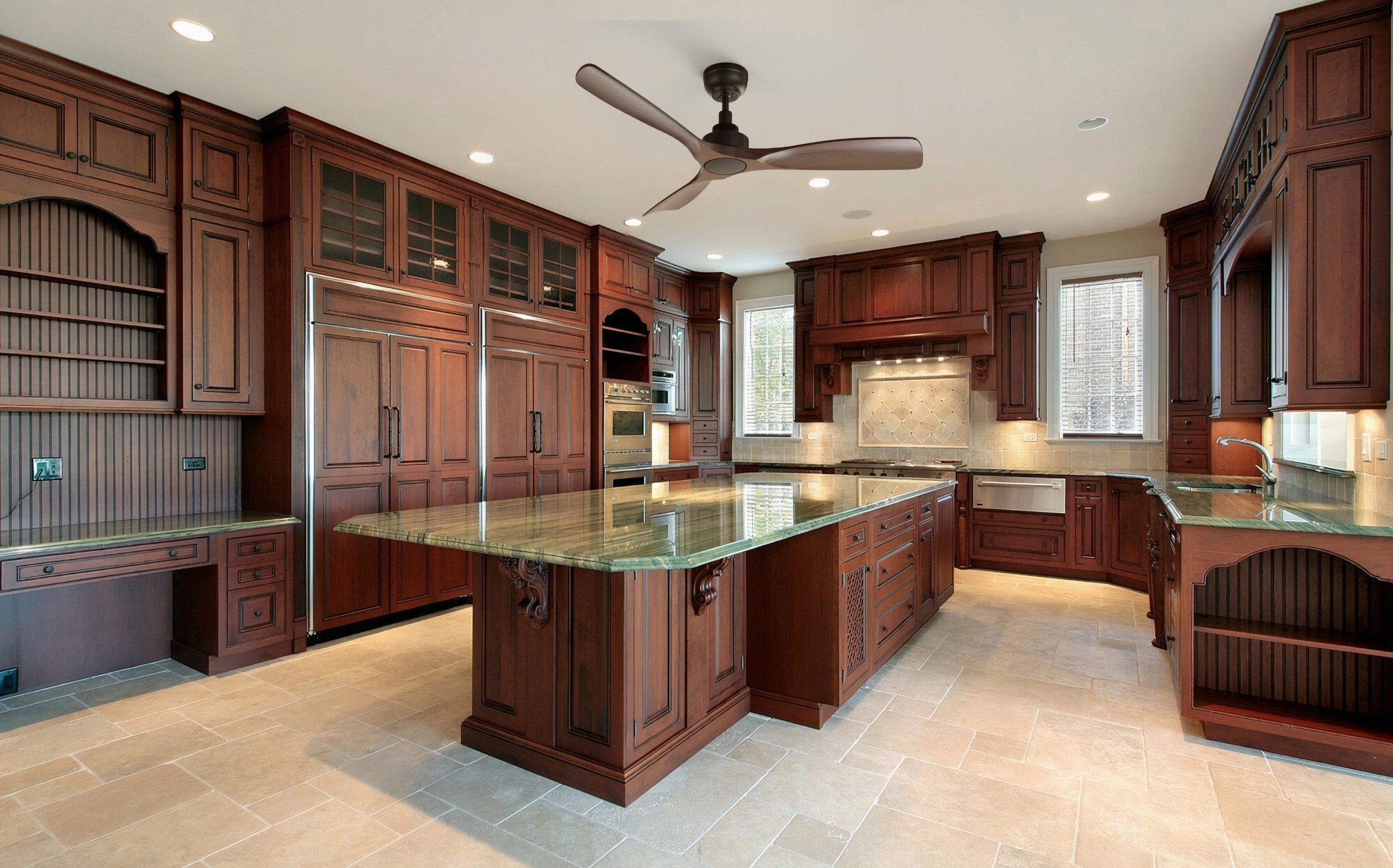 A spacious, luxurious kitchen features extensive, dark cherry wood cabinetry and light beige tiled flooring. The counters and large central island are topped with green granite countertops. A dark bronze or black Smafan Kilk smart ceiling fan hangs from the ceiling. Built-in stainless steel appliances, a farmhouse sink, and a dedicated desk area are also visible.